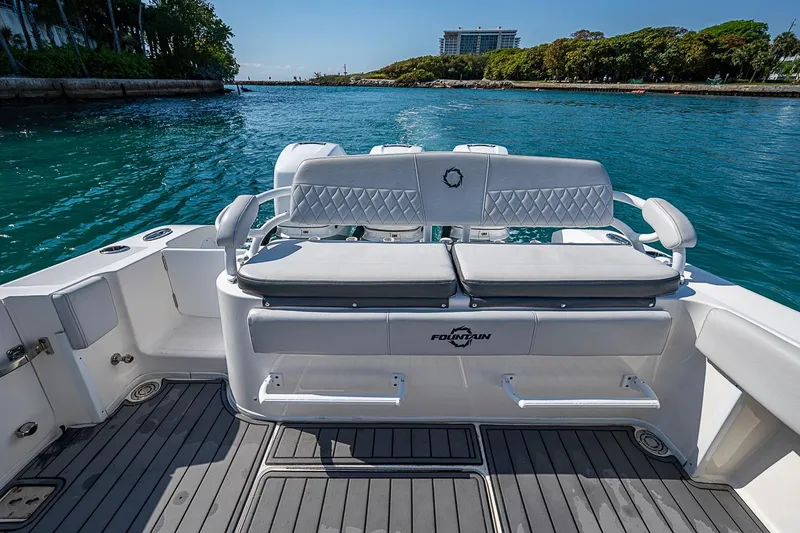 Slide: The Image of 2020 Fountain 38 Center Console boat with cushioned seating, on a scenic waterway. - 5