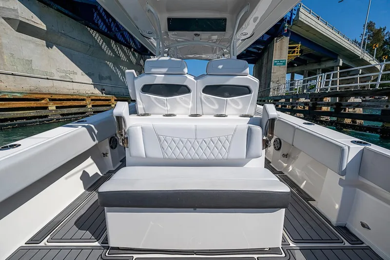 Slide: The Image of 2020 Fountain 38 Center Console boat interior with luxurious seating under a bridge. - 6