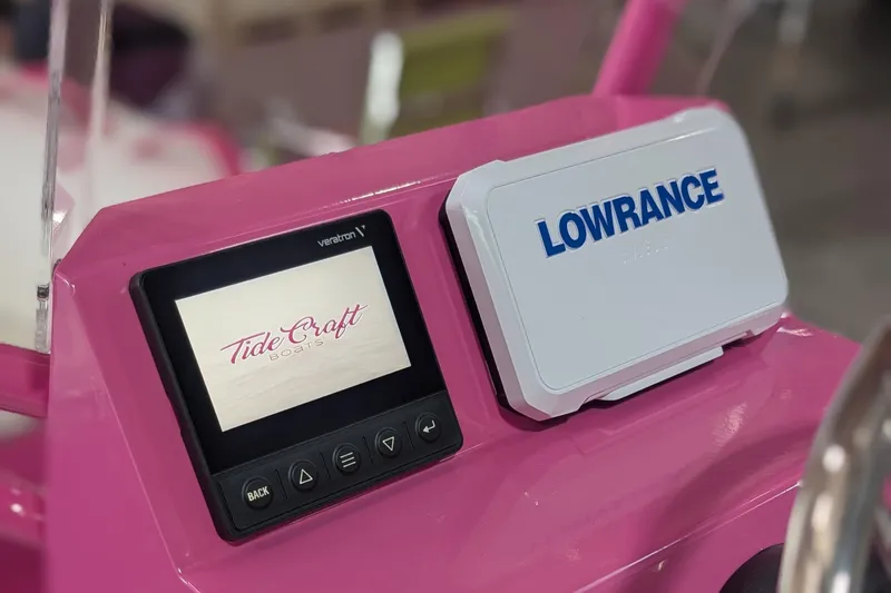 Slide: The Image of Pink dashboard of 2026 Tide Craft Custom Catalina 13 with Lowrance display. - 3