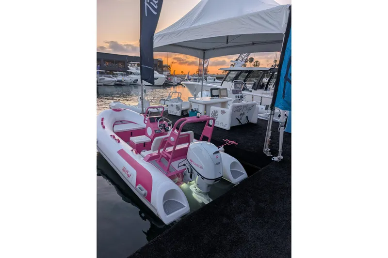 Slide: The Image of Custom pink and white Catalina 13 boat by Tide Craft, docked at sunset, 2026 model. - 8