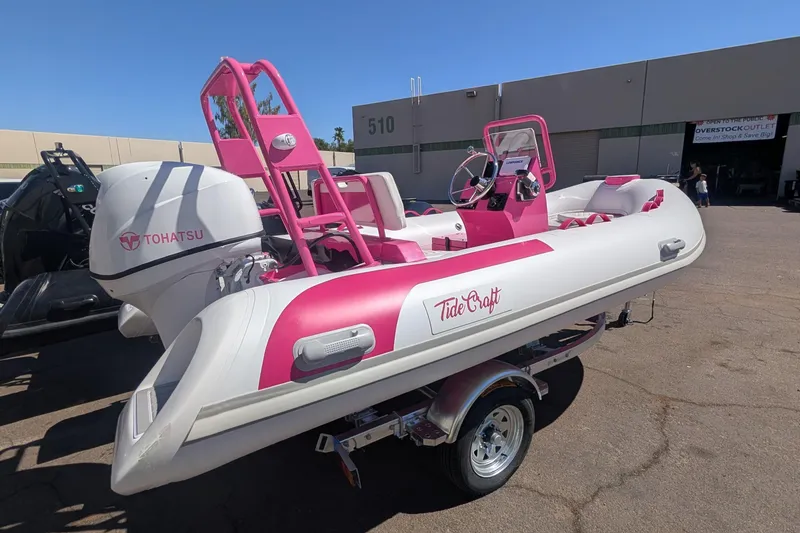 Slide: The Image of 2026 Tide Craft Custom Pink & White Catalina 13 boat with Tohatsu engine on trailer. - 2
