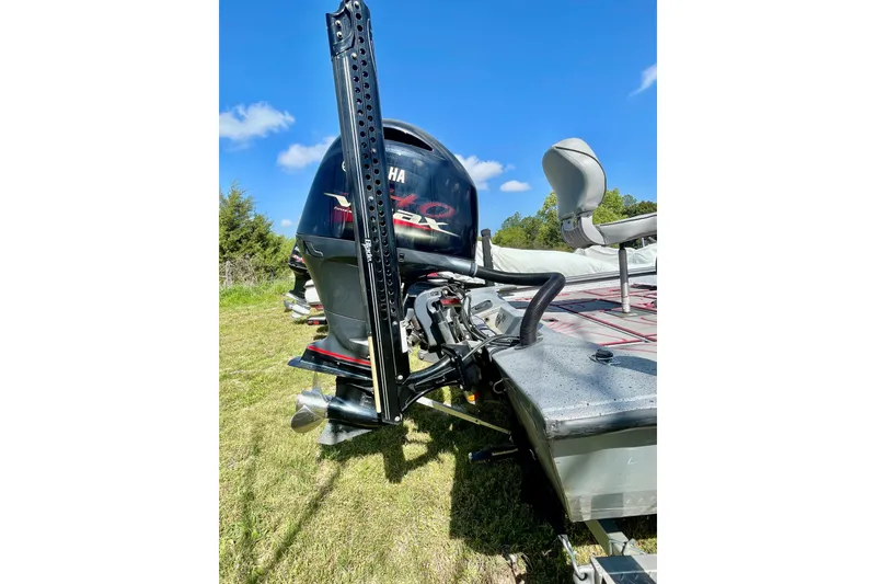 Slide: The Image of 2020 Xpress X21 Pro boat with Yamaha motor, parked on grass under blue sky. - 9