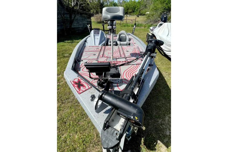Slide: The Image of 2020 Xpress X21 Pro fishing boat with advanced trolling motor on grassy area. - 2