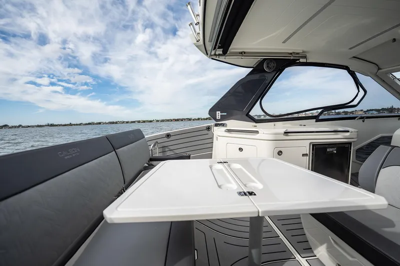 Slide: The Image of 2023 Galeon 325 GTO yacht interior with sleek seating and ocean view. - 15