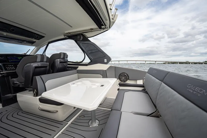 Slide: The Image of 2023 Galeon 325 GTO yacht interior with sleek seating and modern design on open water. - 21