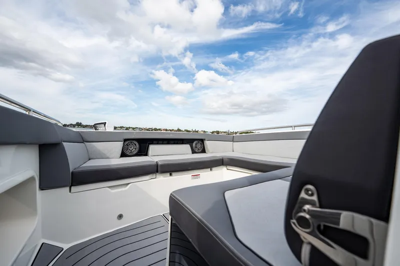 Slide: The Image of 2023 Galeon 325 GTO boat interior with sleek seating and modern design under a blue sky. - 23