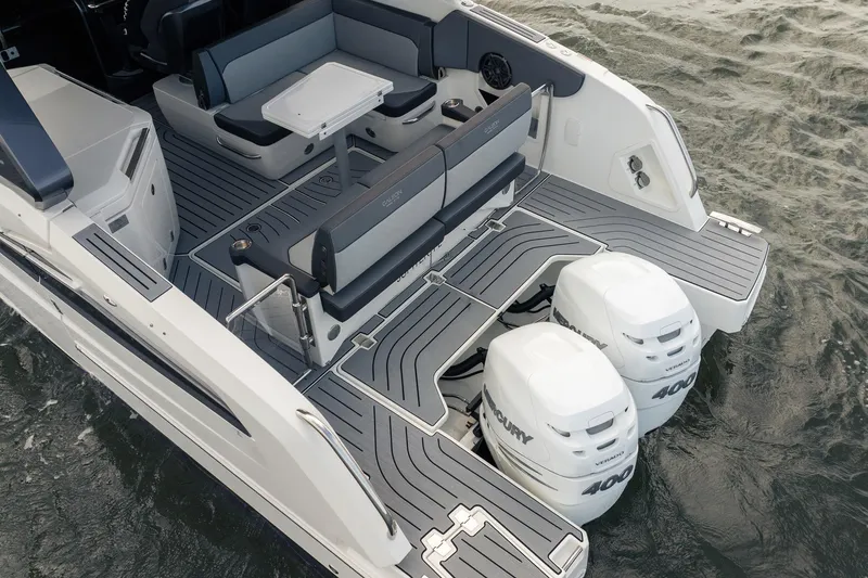 Slide: The Image of 2023 Galeon 325 GTO boat with dual Mercury 400 engines and sleek seating area. - 30