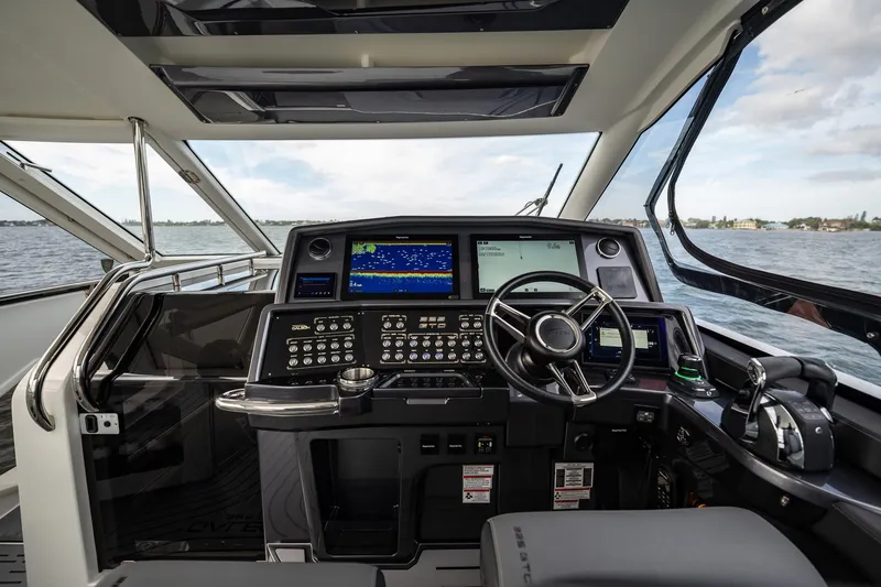 Slide: The Image of Cockpit of 2023 Galeon 325 GTO yacht with advanced navigation controls and sea view. - 41