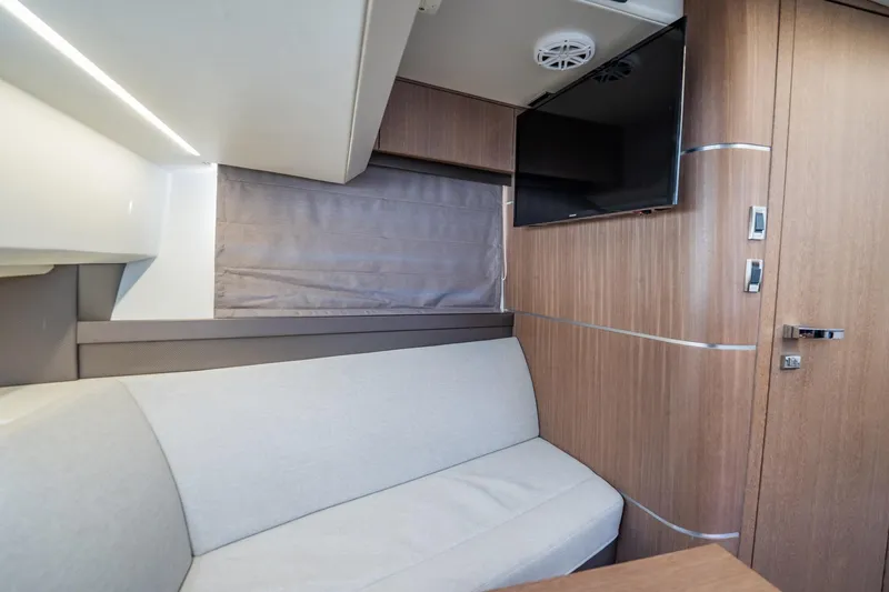 Slide: The Image of Interior of 2023 Galeon 325 GTO yacht with modern wood paneling and cozy seating. - 48