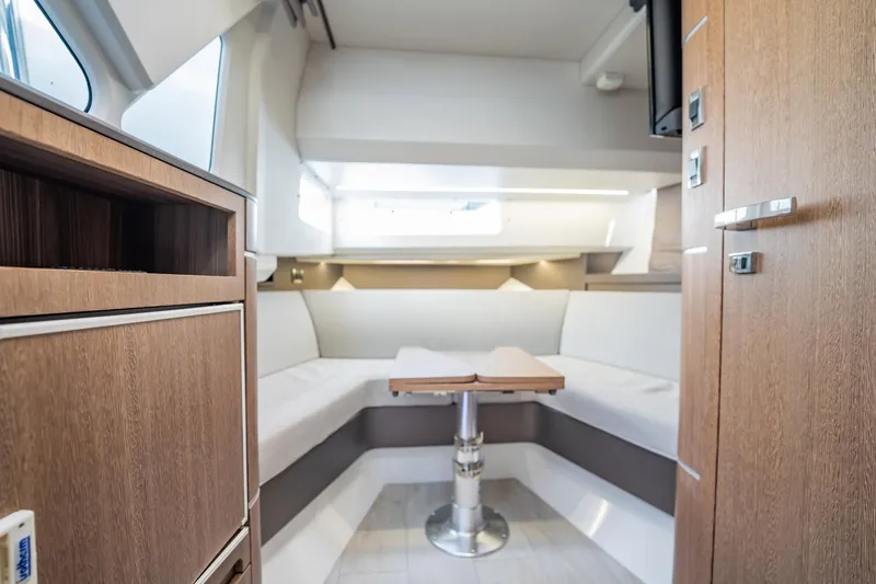 Slide: The Image of Interior of 2023 Galeon 325 GTO yacht with modern wood finish and cozy seating area. - 50