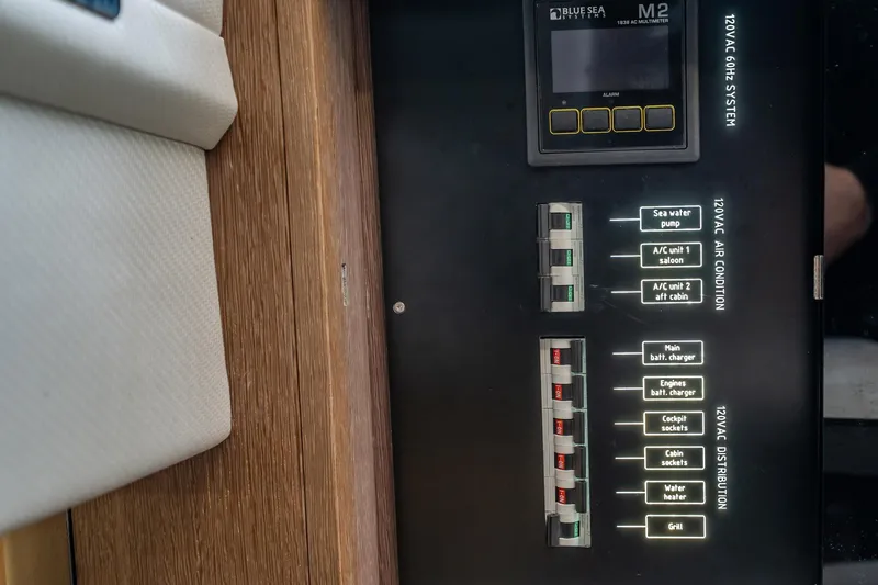 Slide: The Image of Electrical panel on 2023 Galeon 325 GTO yacht, featuring circuit breakers and control switches. - 52