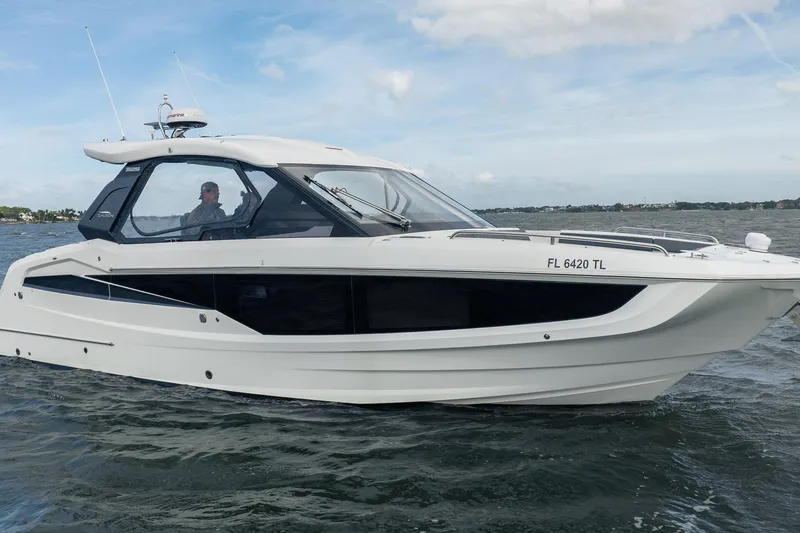 Slide: The Image of 2023 Galeon 325 GTO cruising on open water under a clear sky. - 9
