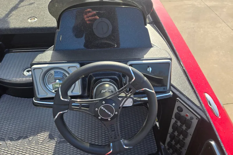 Slide: The Image of Steering wheel and dashboard of a 2027 Caymas 201 Pro boat. - 24