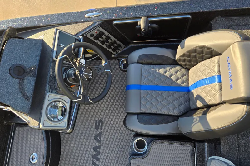 Slide: The Image of 2027 Caymas 201 Pro boat interior with steering wheel and quilted seat design. - 6
