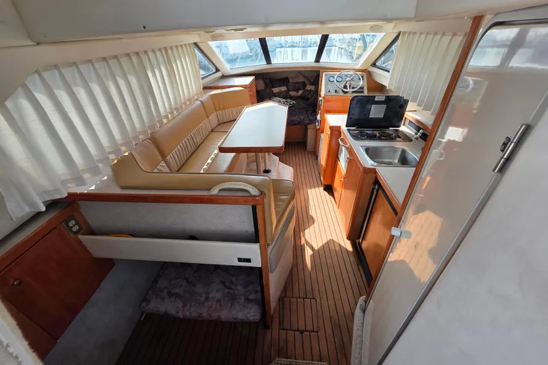 Slide: The Image of Interior of 1999 Bayliner 2858 Ciera Command Bridge with seating, kitchenette, and helm. - 14