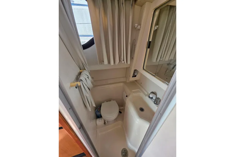 Slide: The Image of Bathroom interior of 1999 Bayliner 2858 Ciera Command Bridge with sink and toilet. - 18