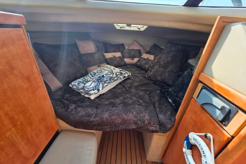 Slide: The Image of Cozy cabin interior of 1999 Bayliner 2858 Ciera Command Bridge with plush bedding. - 20