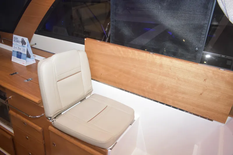 Slide: The Image of 2026 Cutwater C-32 CB interior with beige seat and wooden paneling. - 10
