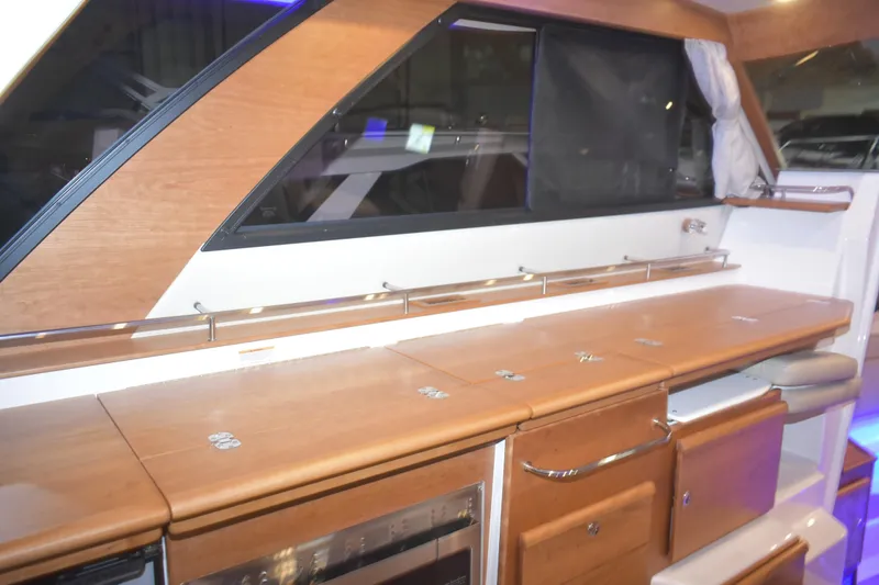 Slide: The Image of Interior of 2026 Cutwater C-32 CB yacht with sleek wooden cabinetry and modern design. - 16