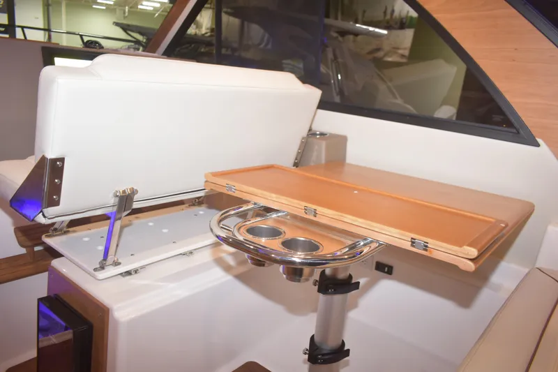 Slide: The Image of Interior of 2026 Cutwater C-32 CB boat featuring a foldable table and seating area. - 19