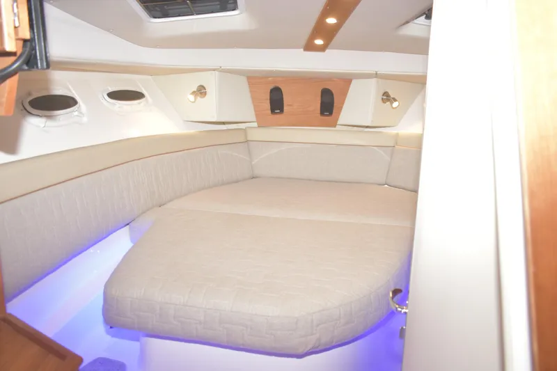 Slide: The Image of 2026 Cutwater C-32 CB cabin interior with cozy bed and ambient lighting. - 22