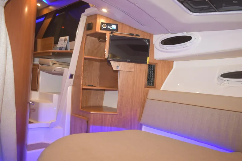 Slide: The Image of Interior of 2026 Cutwater C-32 CB boat with modern wood finish and ambient lighting. - 23