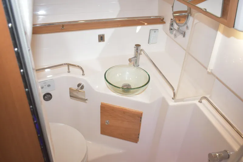 Slide: The Image of Compact bathroom in 2026 Cutwater C-32 CB boat with glass sink and modern fixtures. - 24