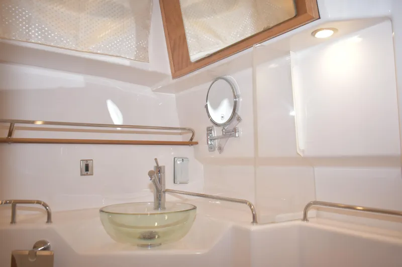 Slide: The Image of Modern bathroom interior of 2026 Cutwater C-32 CB yacht with glass sink and porthole. - 26