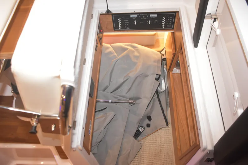 Slide: The Image of Interior storage area of 2026 Cutwater C-32 CB boat with control panel. - 28
