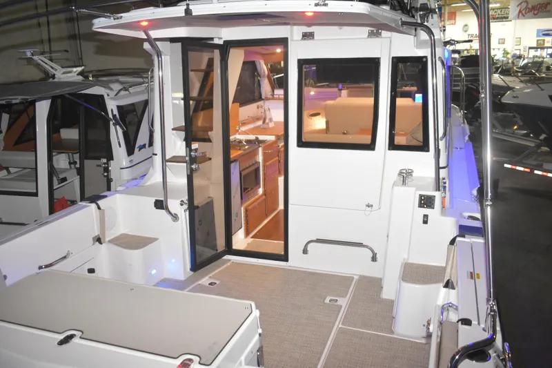 Slide: The Image of 2026 Cutwater C-32 CB boat interior with modern kitchen and seating area. - 29
