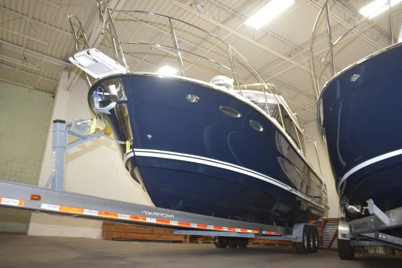 Slide: The Image of 2026 Cutwater C-32 CB boat on trailer in indoor storage facility. - 3