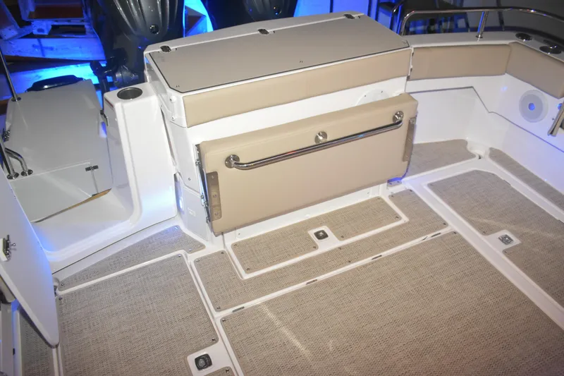 Slide: The Image of 2026 Cutwater C-32 CB boat interior with beige seating and carpeted flooring. - 30