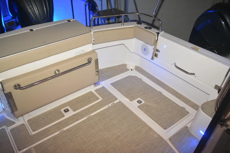 Slide: The Image of 2026 Cutwater C-32 CB boat interior with beige seating and carpeted flooring. - 31