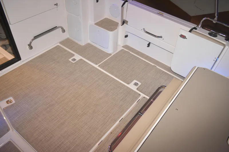 Slide: The Image of 2026 Cutwater C-32 CB boat interior with beige flooring and storage compartments. - 32