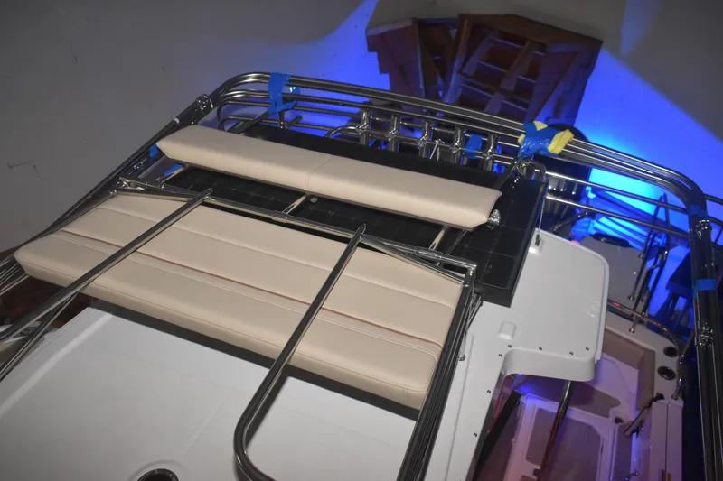 Slide: The Image of 2026 Cutwater C-32 CB boat interior with cushioned seating and stainless steel railings. - 35