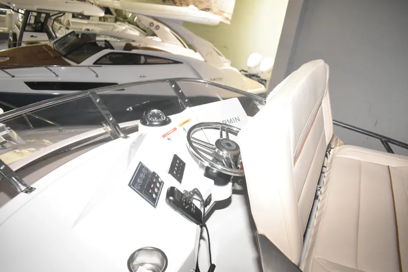 Slide: The Image of Interior view of 2026 Cutwater C-32 CB boat cockpit with steering wheel and controls. - 36