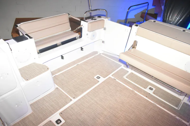Slide: The Image of 2026 Cutwater C-32 CB boat interior with beige seating and carpeted flooring. - 37