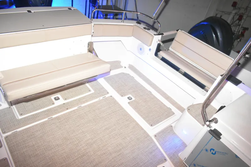 Slide: The Image of 2026 Cutwater C-32 CB boat interior with beige seating and carpeted flooring. - 38