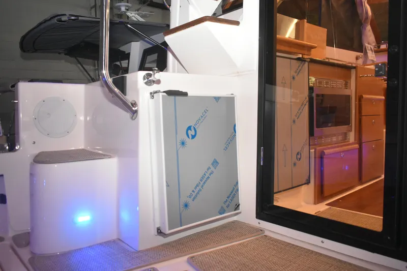 Slide: The Image of Interior view of 2026 Cutwater C-32 CB boat, featuring modern kitchen and sleek design. - 44
