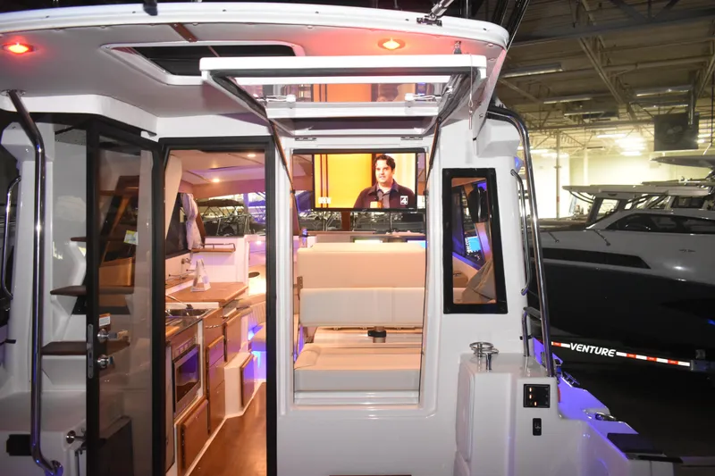 Slide: The Image of Interior view of 2026 Cutwater C-32 CB boat showcasing modern kitchen and seating area. - 45