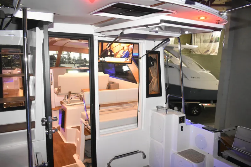 Slide: The Image of Interior view of 2026 Cutwater C-32 CB boat showcasing seating and modern amenities. - 46