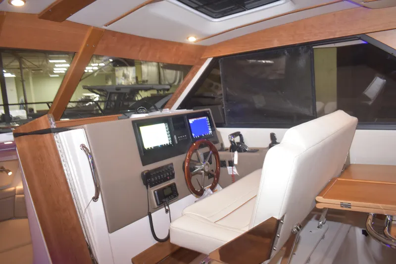Slide: The Image of Interior of 2026 Cutwater C-32 CB boat with modern helm and seating. - 5