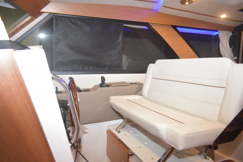 Slide: The Image of Interior of 2026 Cutwater C-32 CB boat with white seating and modern design. - 6