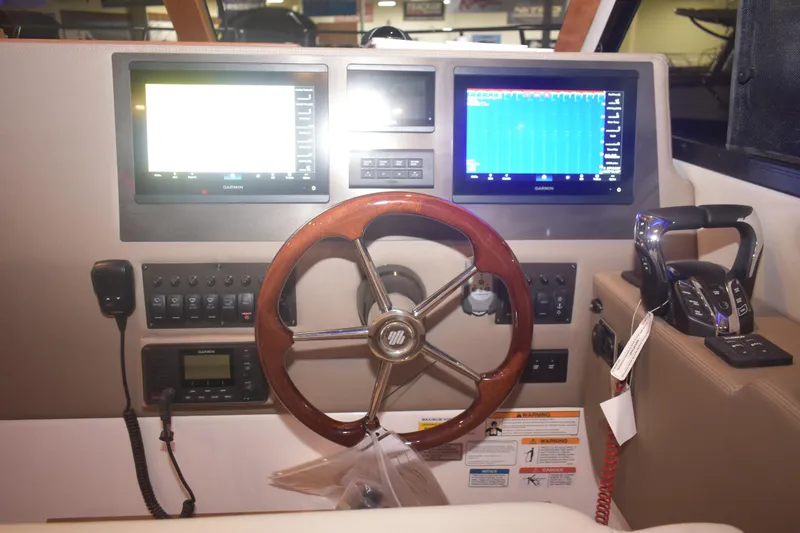 Slide: The Image of Helm of 2026 Cutwater C-32 CB with dual Garmin displays and wooden steering wheel. - 8