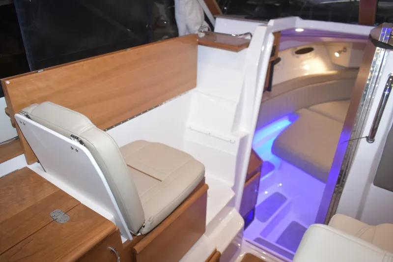 Slide: The Image of Interior of 2026 Cutwater C-32 CB boat with seating and ambient lighting. - 9