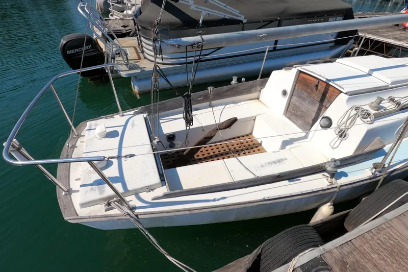 Slide: The Image of 1976 Cape Dory 25 sailboat docked, featuring a clean deck and classic design. - 2