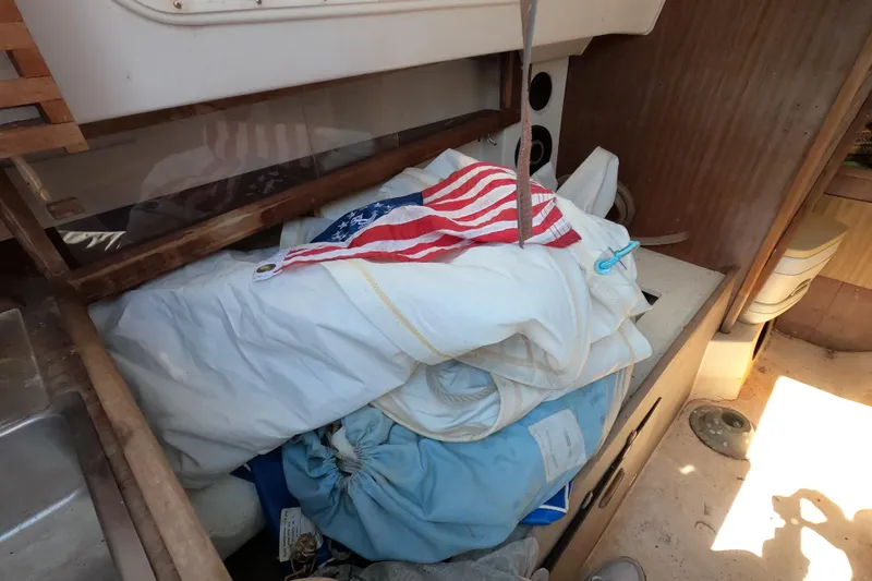 Slide: The Image of Interior of a 1976 Cape Dory 25 sailboat with sails and American flag. - 7