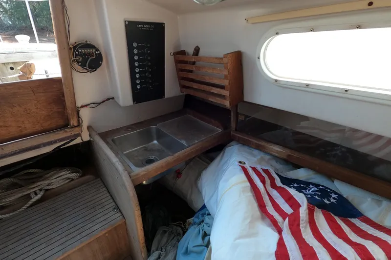 Slide: The Image of Interior of a 1976 Cape Dory 25 sailboat with sink and American flag. - 8