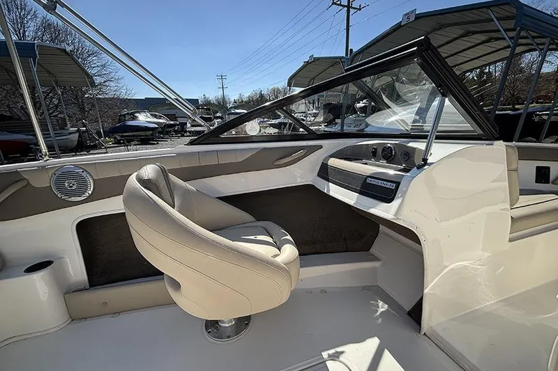 Slide: The Image of 2016 Bayliner 185 Bowrider interior with beige seating and dashboard view. - 10