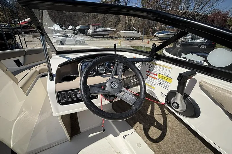 Slide: The Image of 2016 Bayliner 185 Bowrider dashboard with steering wheel and control panel. - 14